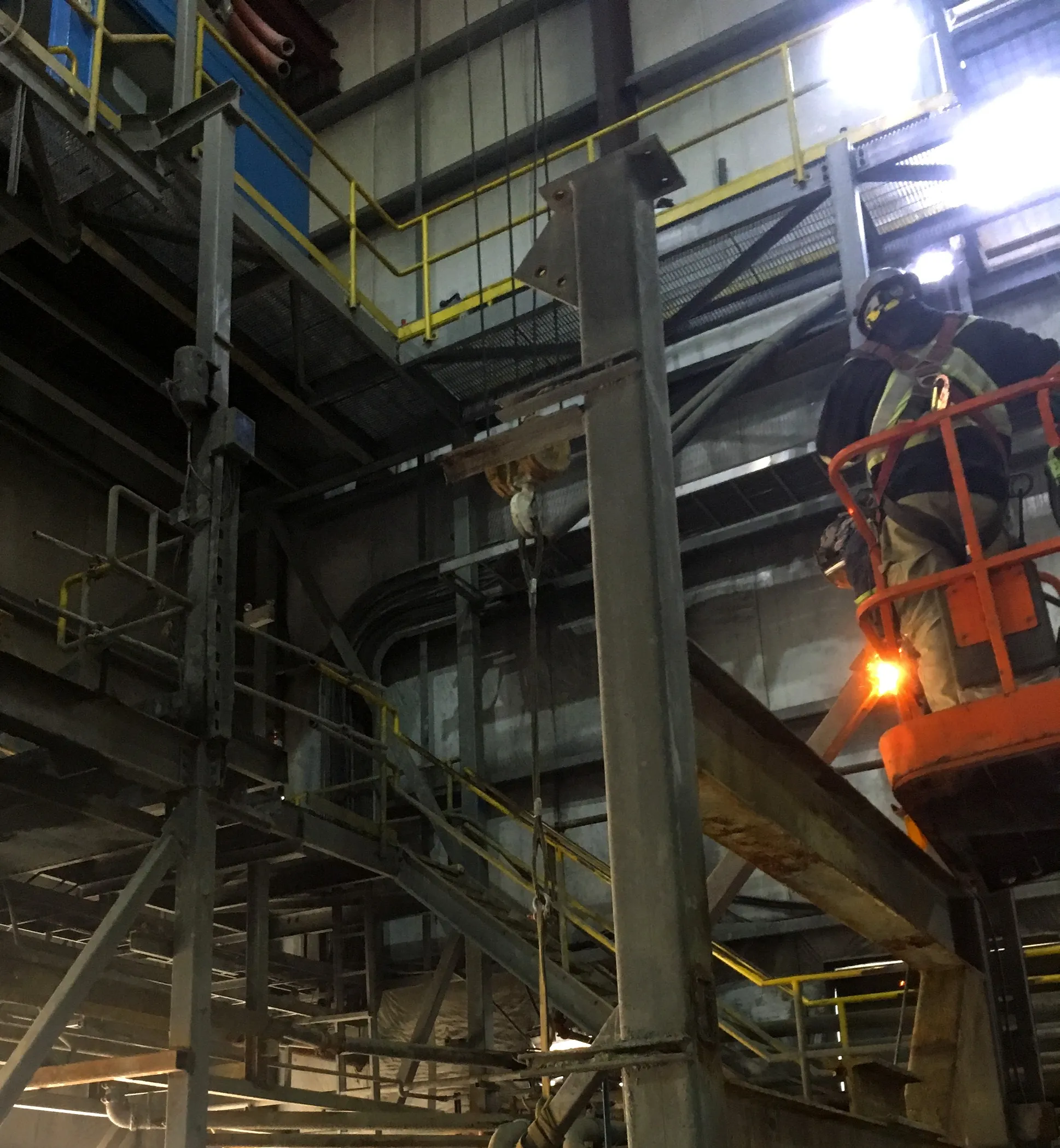 Field crew welding inside an industrial plant